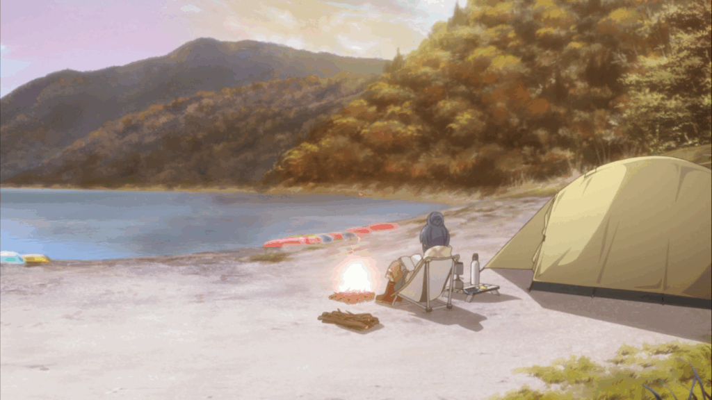 A scene from "Laid-back Camp" in which one of the main characters relaxes in a camping chair by a fire next to a calm lake. 