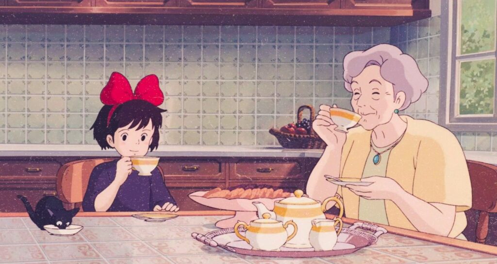 Kiki, a young girl in a black dress and wearing a red bow, and an older woman drinking tea from "KIki's Delivery Service"