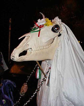 A skeletal horse with a floral crown and a white crown